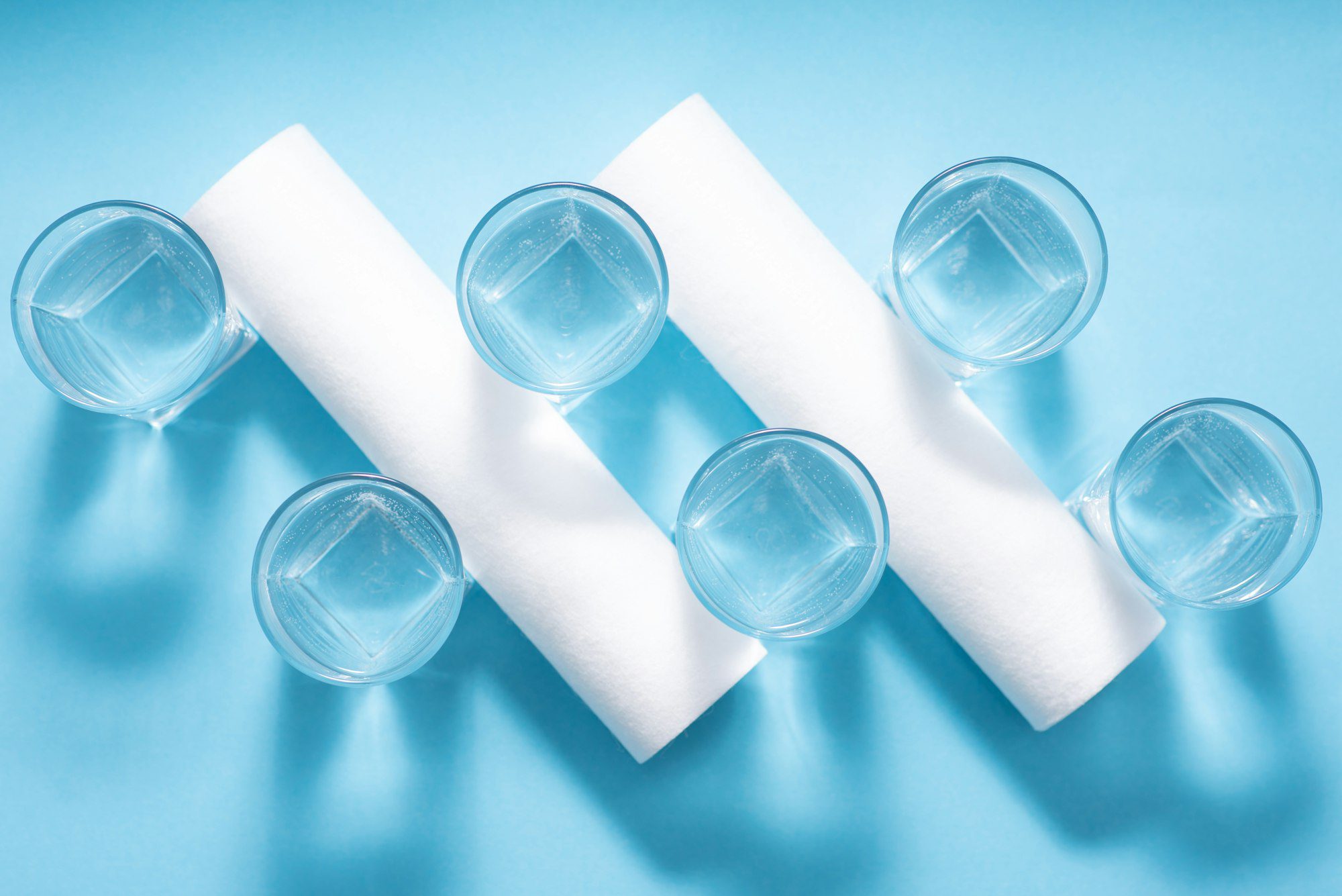Glasses of dirty and clear water and filter cartridges to domestic water treatment systems